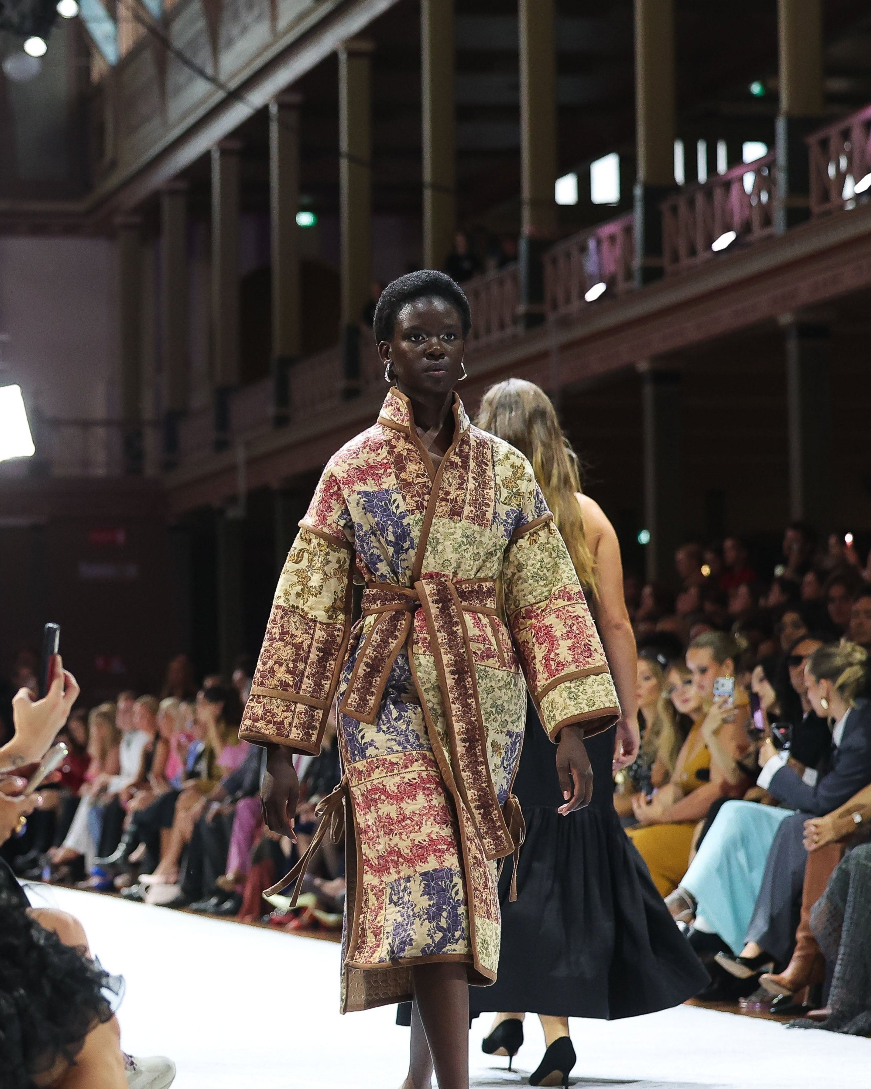 Australian designer: wool patchwork quilted coat fashion model on the runway at Melbourne Fashion Festival